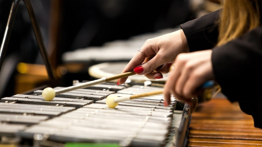 Woman playing the Glockenspiel with mallets