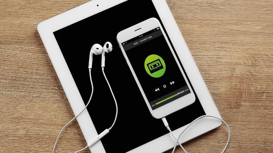 Tablet, Smartphone, and Headphones on Wooden Table