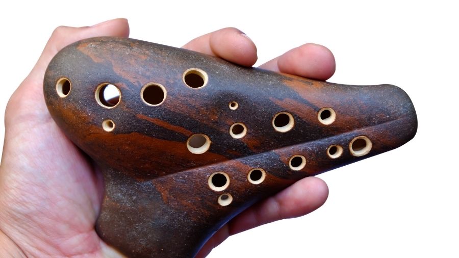 Brown ocarina held in one hand