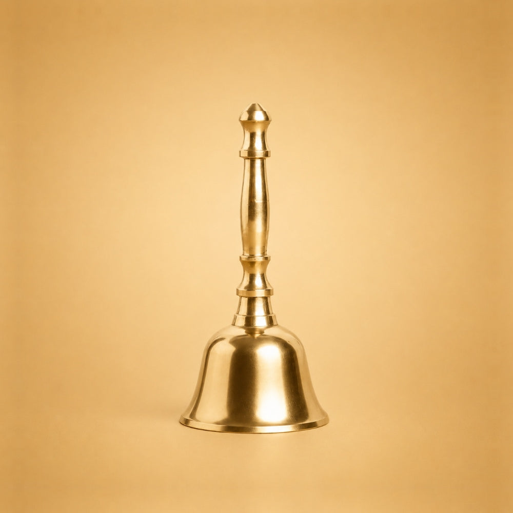 A polished brass bell with a matching handle, centered against a warm, solid gold background.