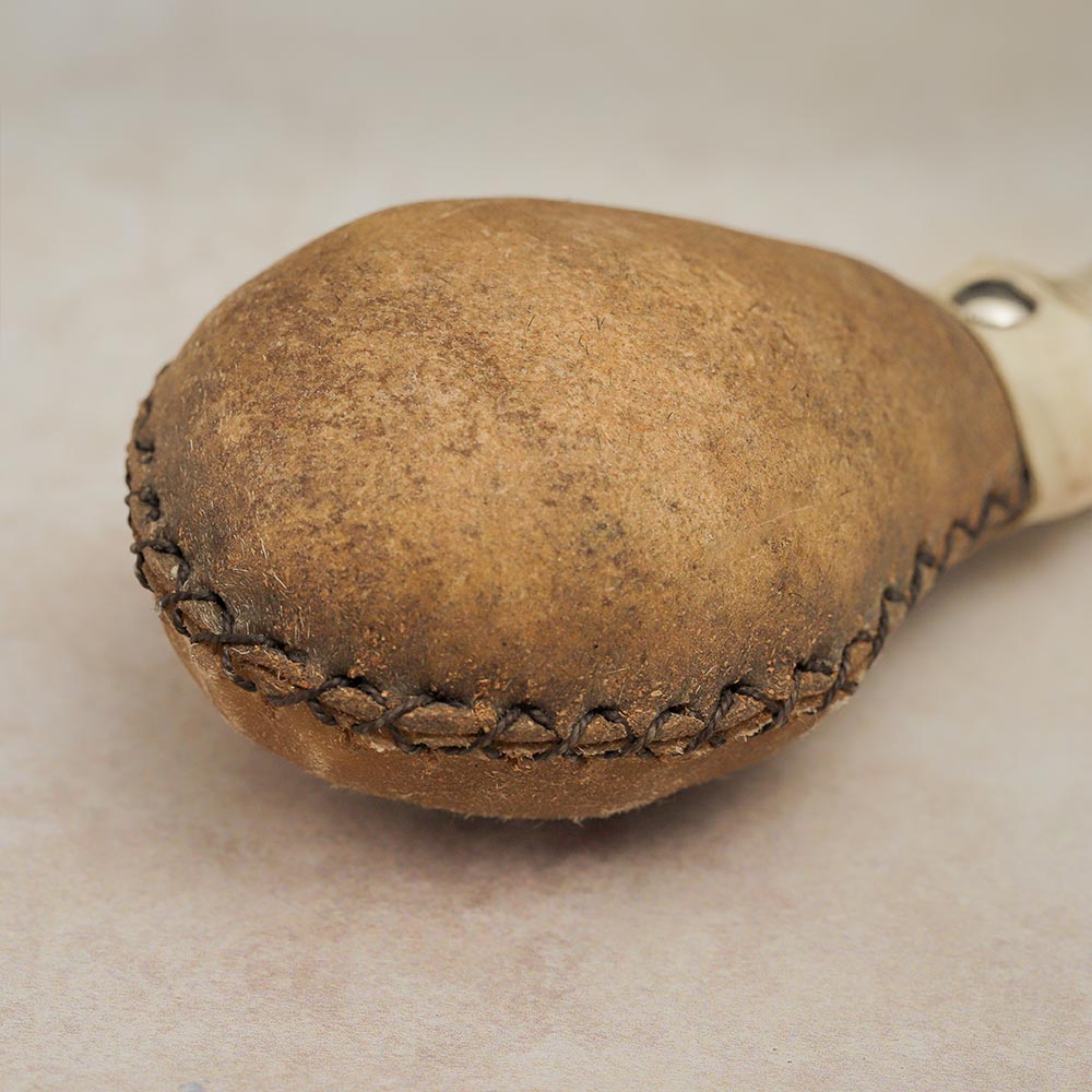 Close-up of the Khenji shamanic shaker head, featuring natural animal hide for a textured, authentic appearance.