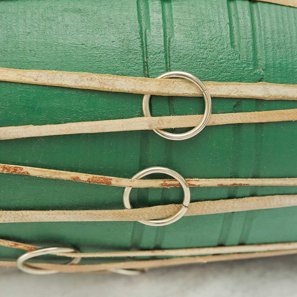 A close-up of the Nepalese Green Madal Drum highlighting the tuning rings, showcasing the drum's traditional design and adjustable tension system.