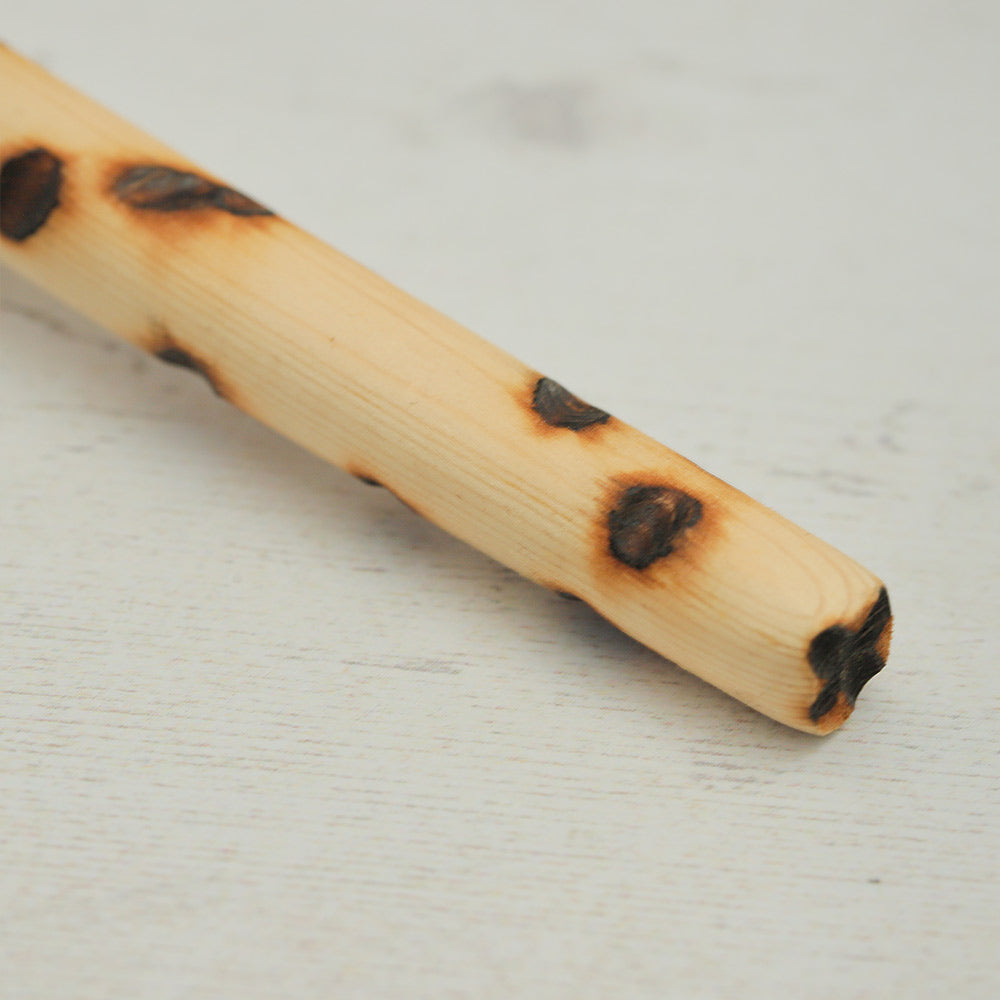 Close up of the Kenyan gourd shakers wooden handle showing texture