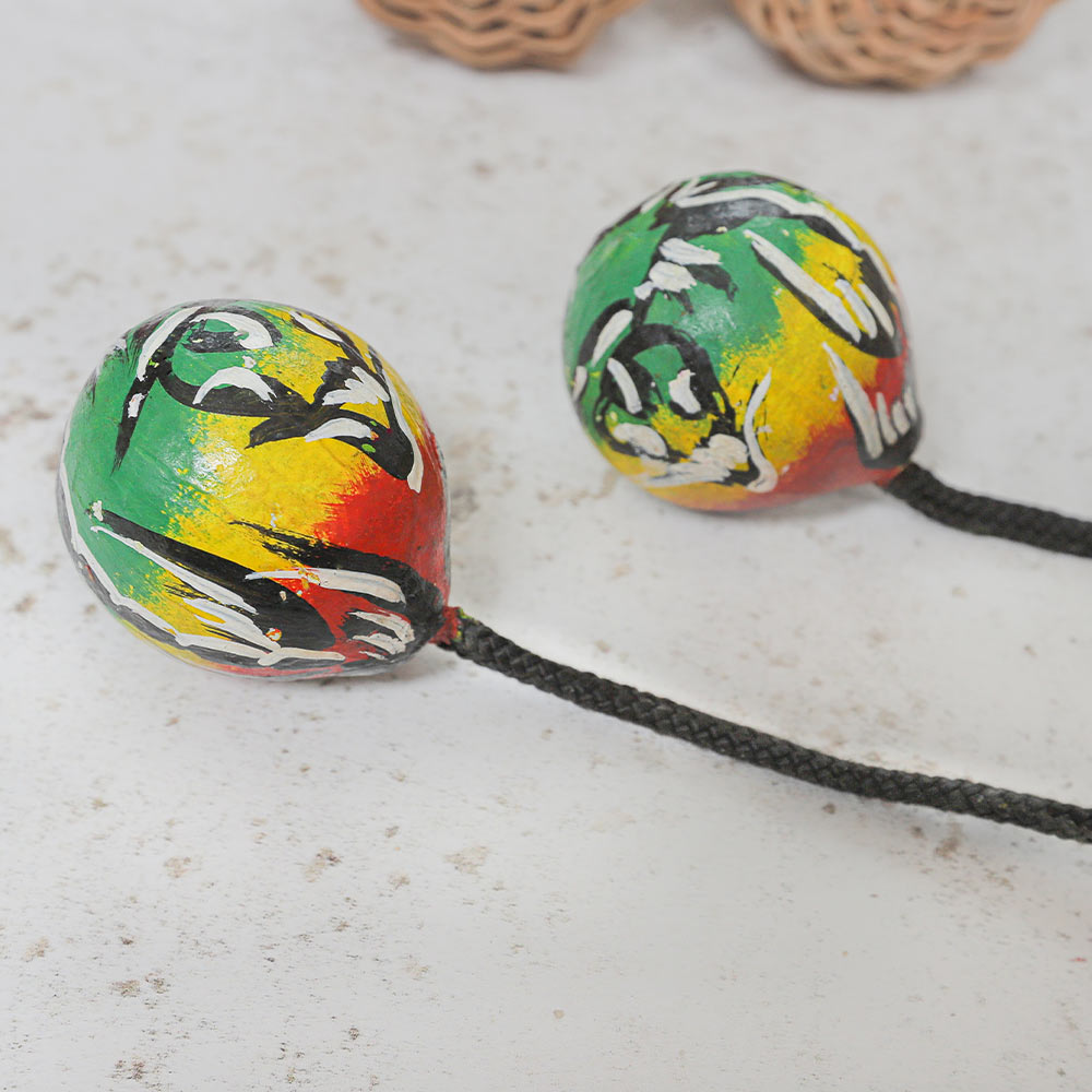 Close up of the hand painted West african kashaka asulato shakers in multicoloured tribal design