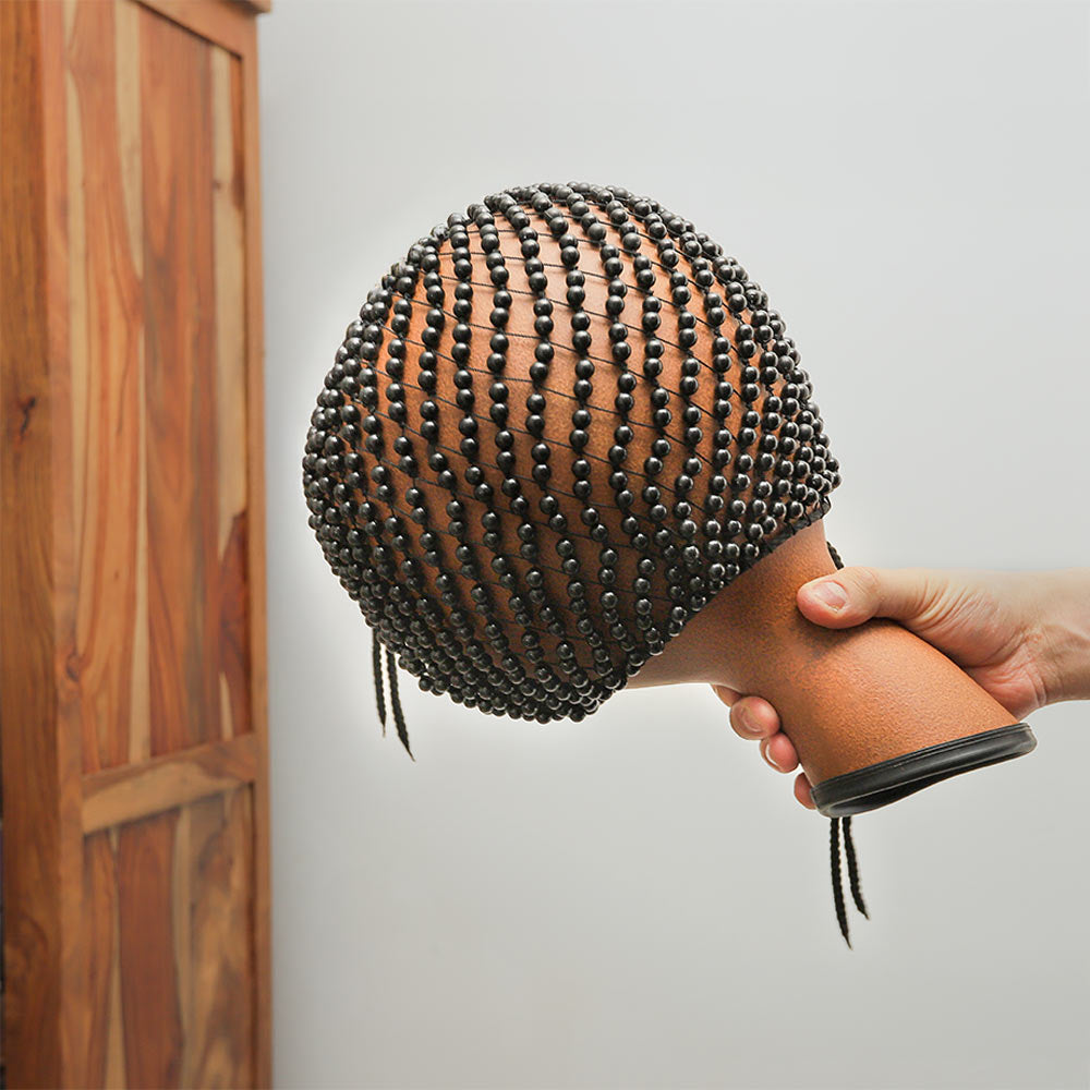 Large Fibreglass Shekere instrument held in hand to show its size and scale.