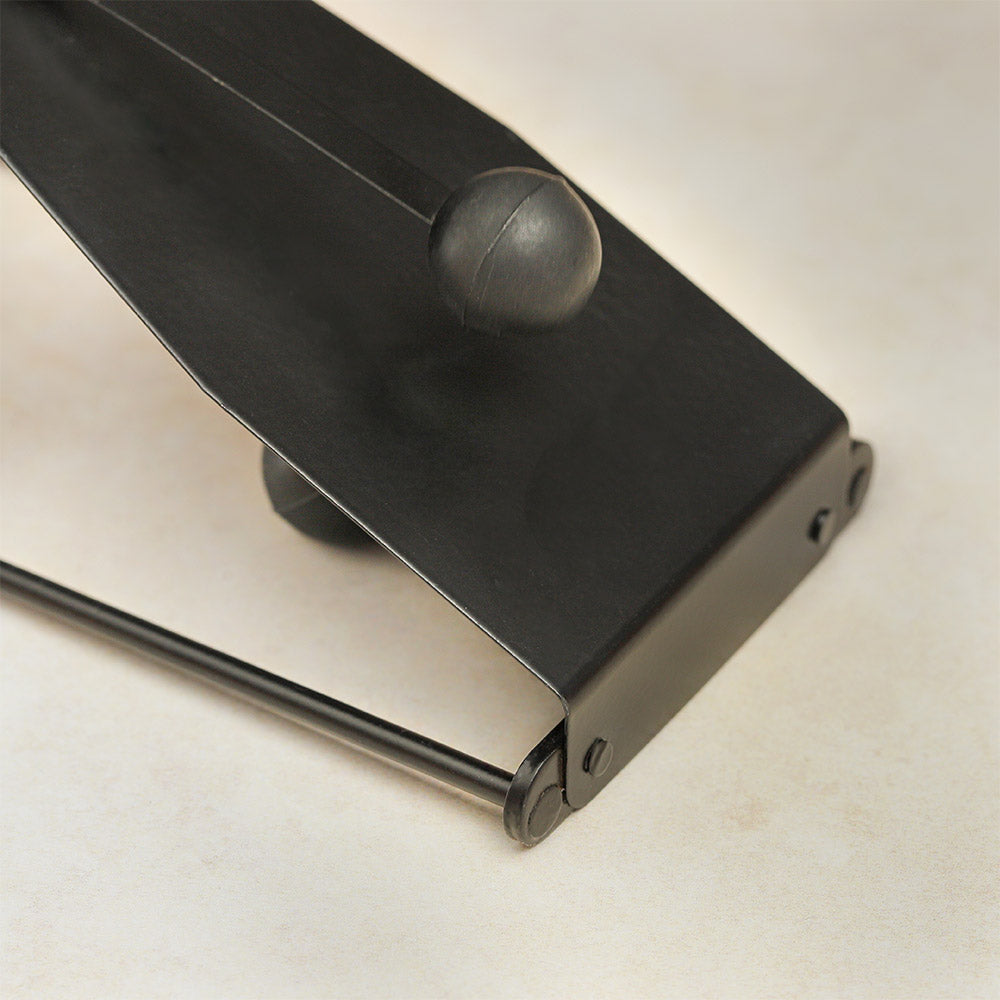 Close-up of the flexatone balls resting on the metal sheet, showing their position and texture.