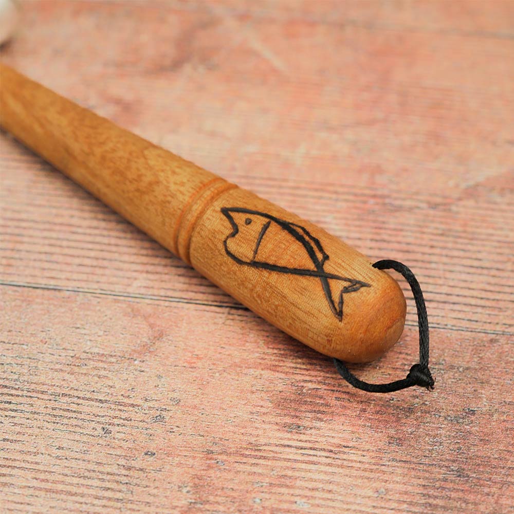 Close-up of the Jati Sleigh Bell Shaker wooden handle, featuring a carved fish design.