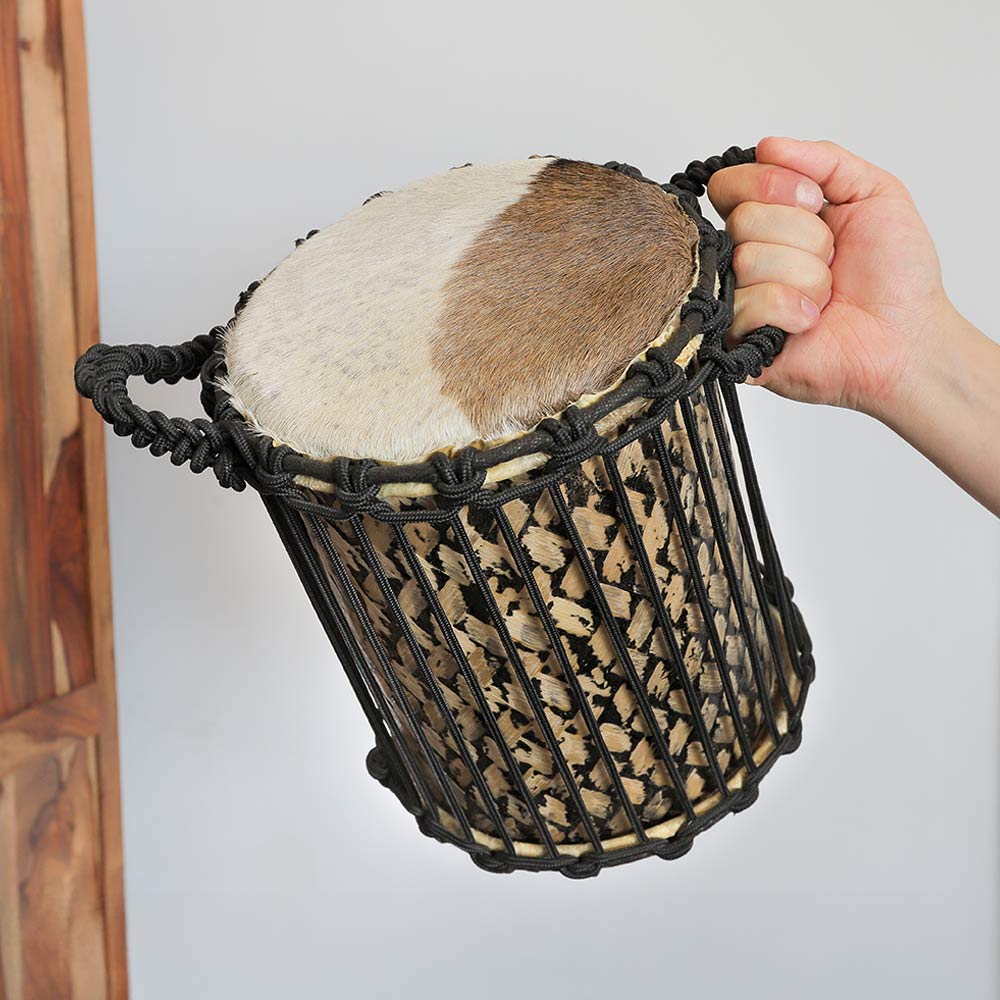 Large kenkeni drum held in the hand to show scale size