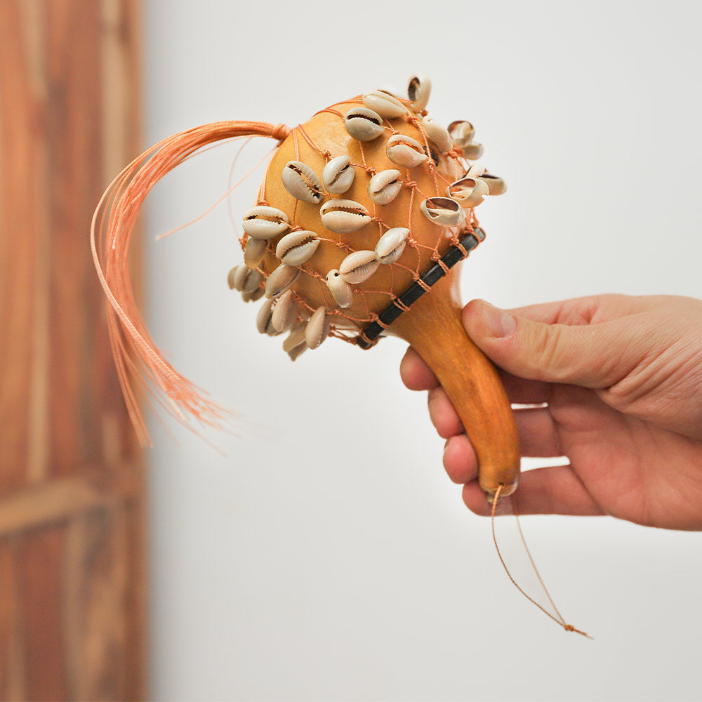 Kenyan Cowrie Calabash Shaker held in hand to show scale size.
