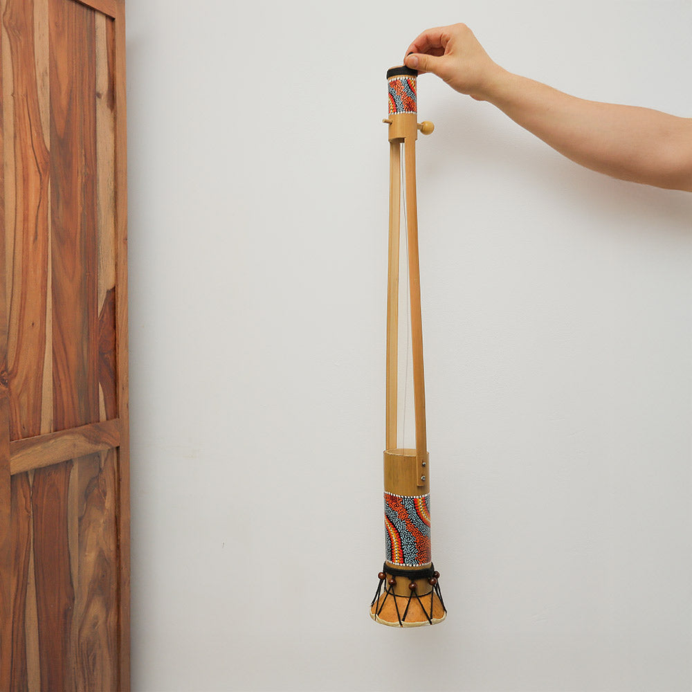 Large hand-painted Begijen Ektara, an Indonesian string instrument, held in hand to show scale.