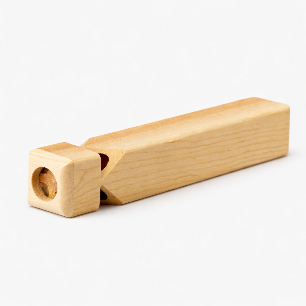 Solid wood matsu train whistle on plain background
