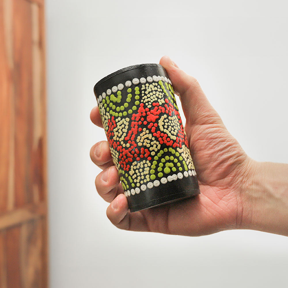 Penebel barrel shaker held in hand, showcasing its size and unique shape.