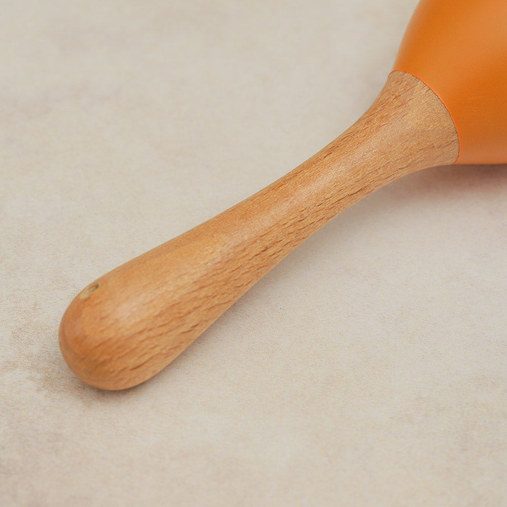 Close-up of the wooden handle of the Rattlesnake Percussion Maraca shaker, highlighting its smooth finish and sturdy construction.