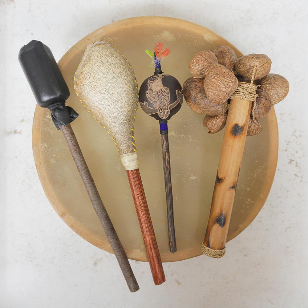 Shamanic instruments bundle including shamanic drum made from cows hide, beater, shamanic shaker, shipibo shaker, and Raha seed stick shaker