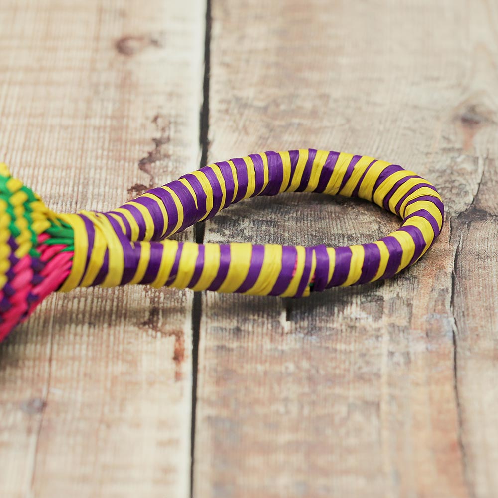 Close-up of the colourful straw handle of the Sonajas rattle, showcasing its vibrant design.