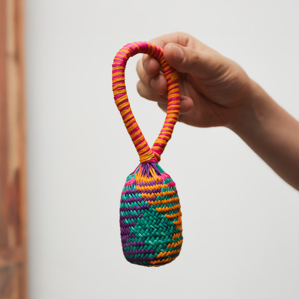 Handmade Sonajas rattle shaker, colourful straw basket percussion instrument from Peru, South America.