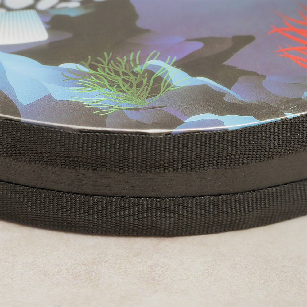 Close-up of the tropical fish ocean drum, showing the side with decorative ribbon and the top with oceanic theme design.