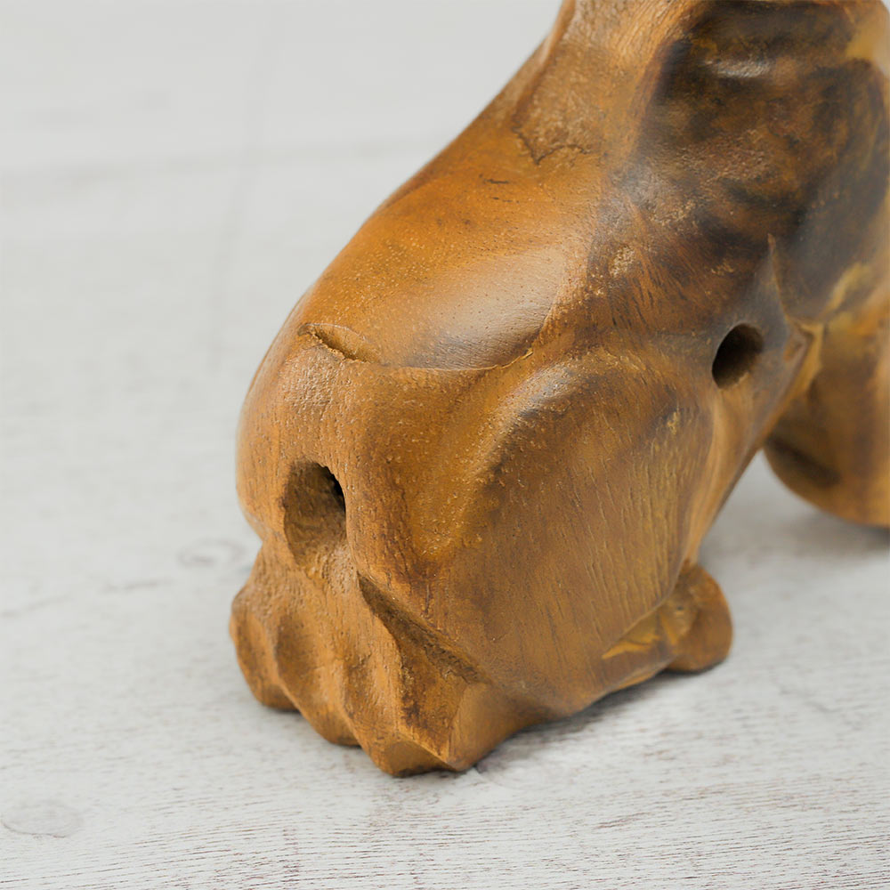Close-up of the back of the wooden howling wolf whistle where the sound is blown.