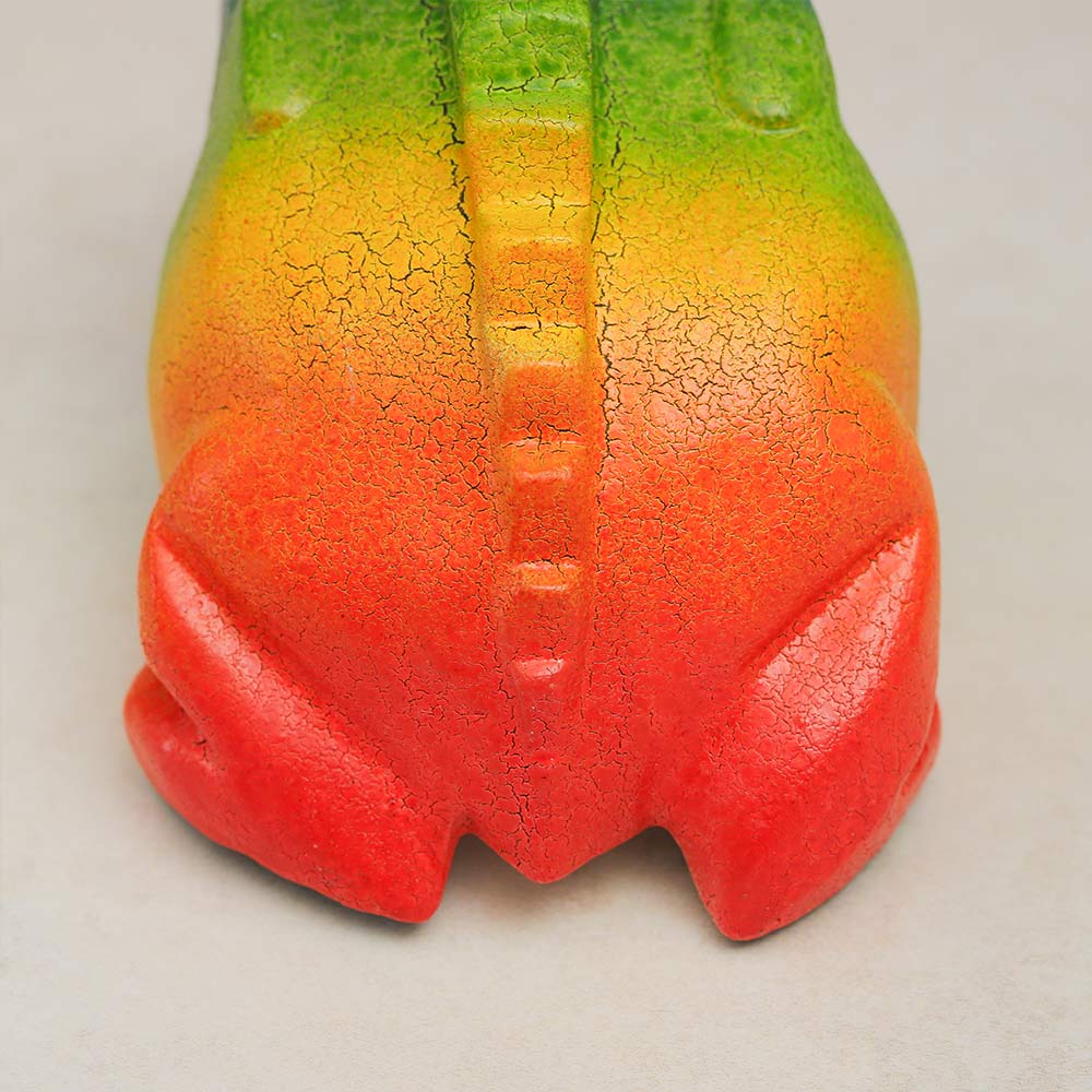 Close-up of the back ridges of the wooden rainbow-coloured frog guiro, highlighting its textured surface.