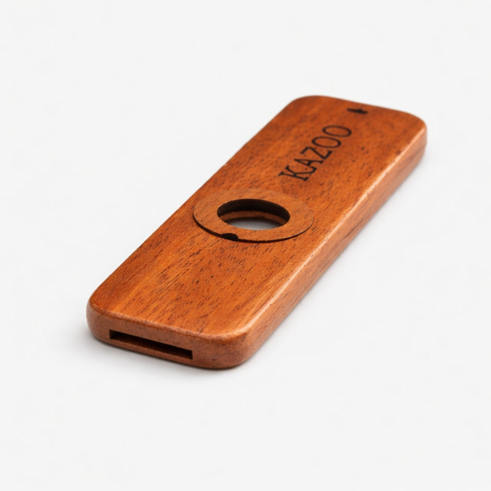 Close up of wooden kazoo mouthpiece with 'Kazoo' branding on a white background