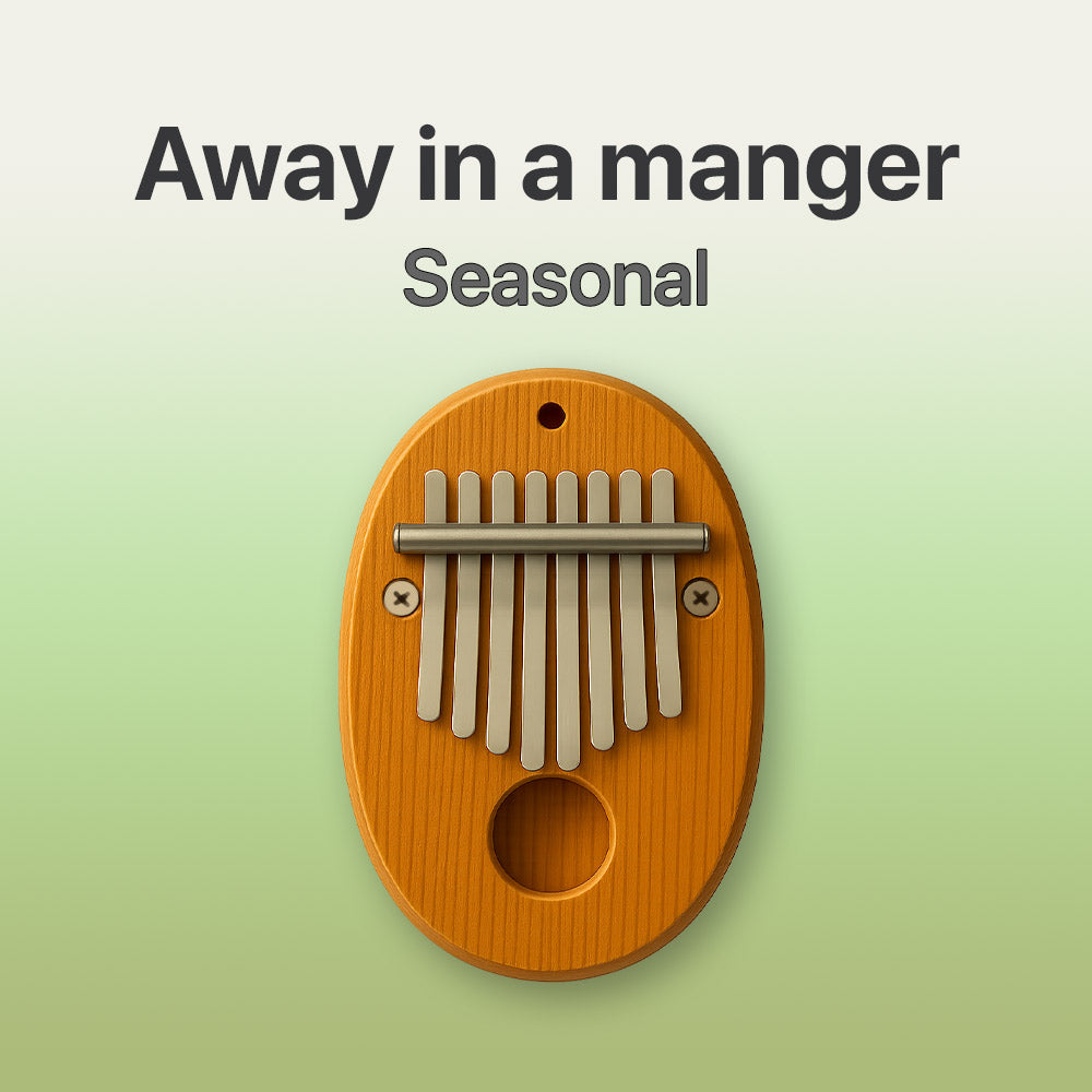 Wooden kalimba on a light green background with text 'Away in a manger Seasonal'.