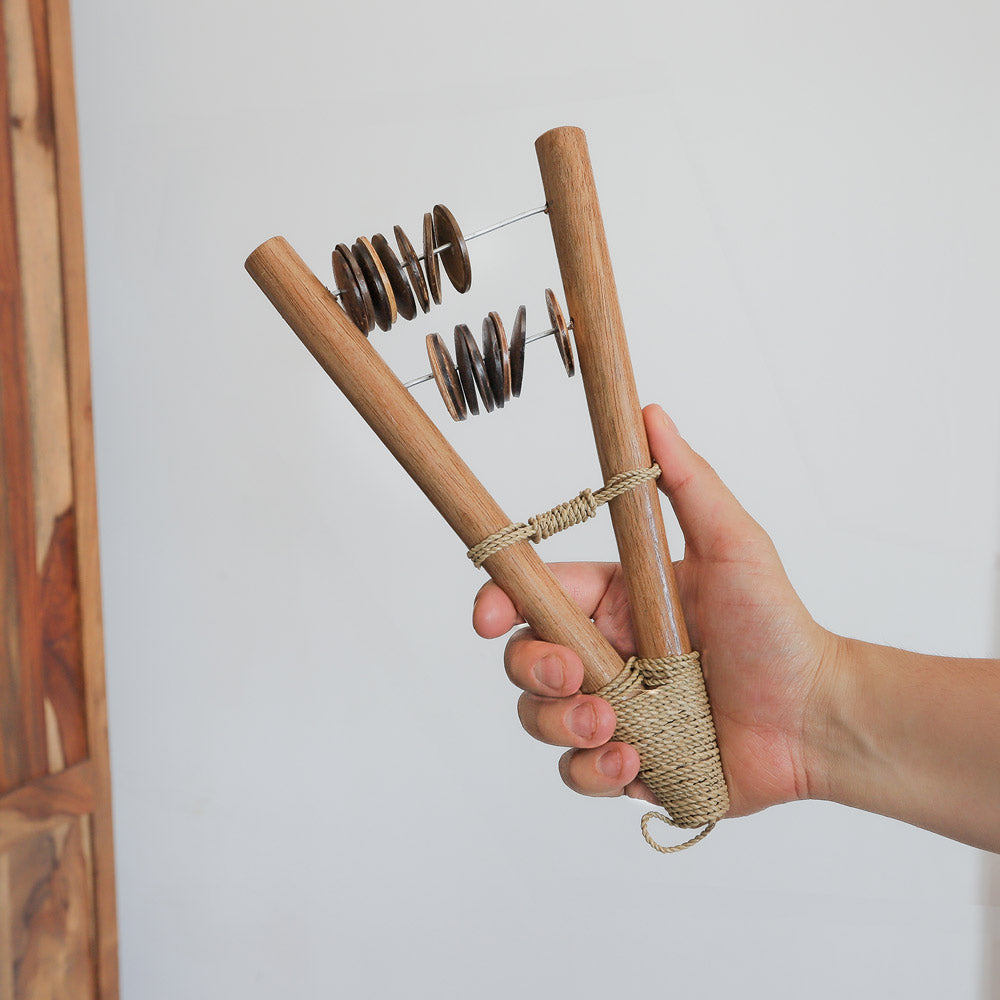 wooden and coconut catapult shaker in hand