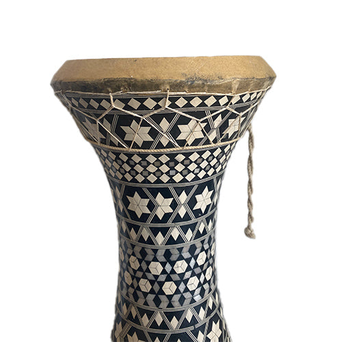 Decorative drum with geometric patterns on a white background
