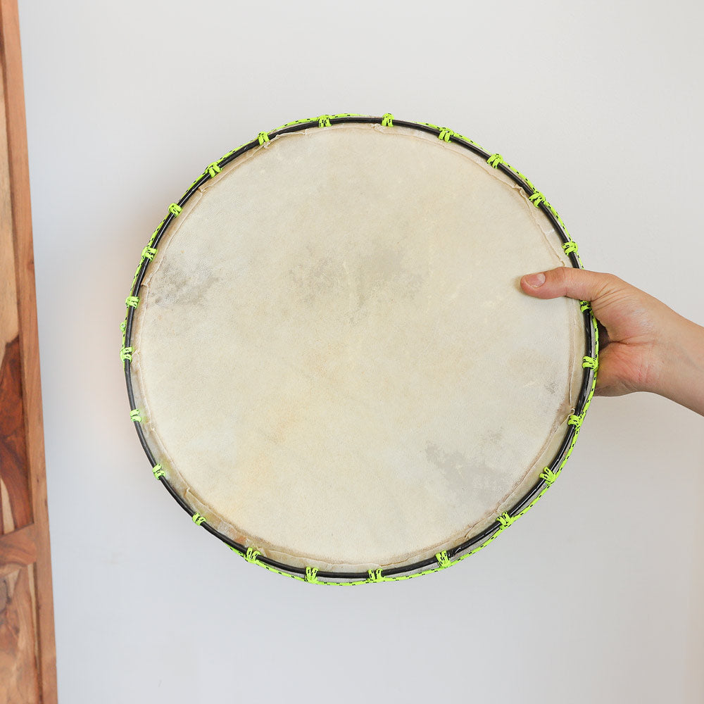 green rope goats hide shamanic drum in hand