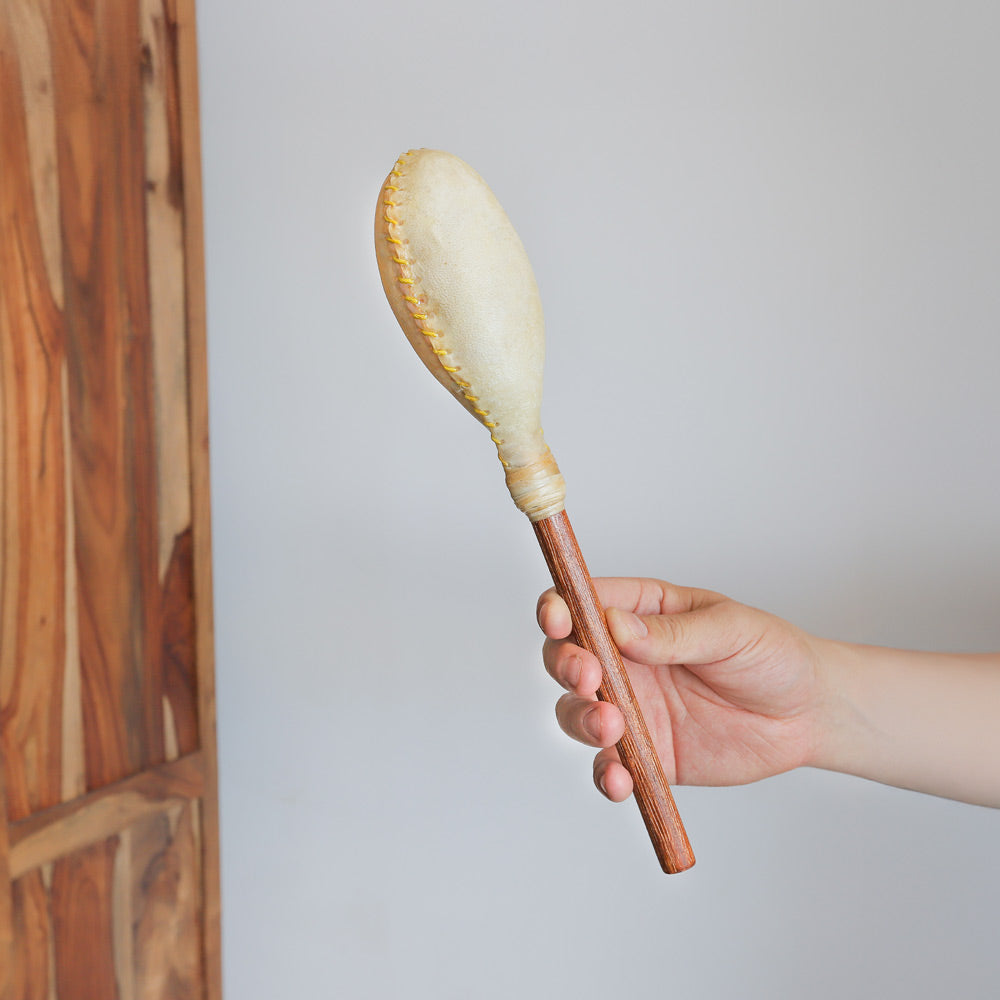 large terre shamanic shaker in hand