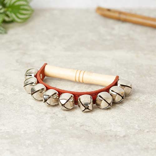 9 sleigh bells attached to leather band