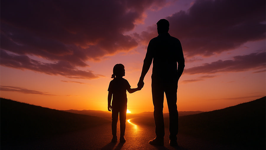 Silhouettes of a parent and child holding hands while standing on a glowing path at sunset, with golden light breaking through clouds to symbolize comfort, resilience, love, and hope for the future.