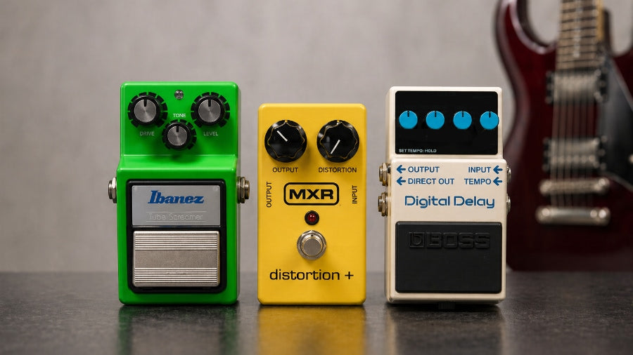 Ibanez overdrive, MXR Distortion+ and BOSS Digital Delay pedals with an electric guitar in the background