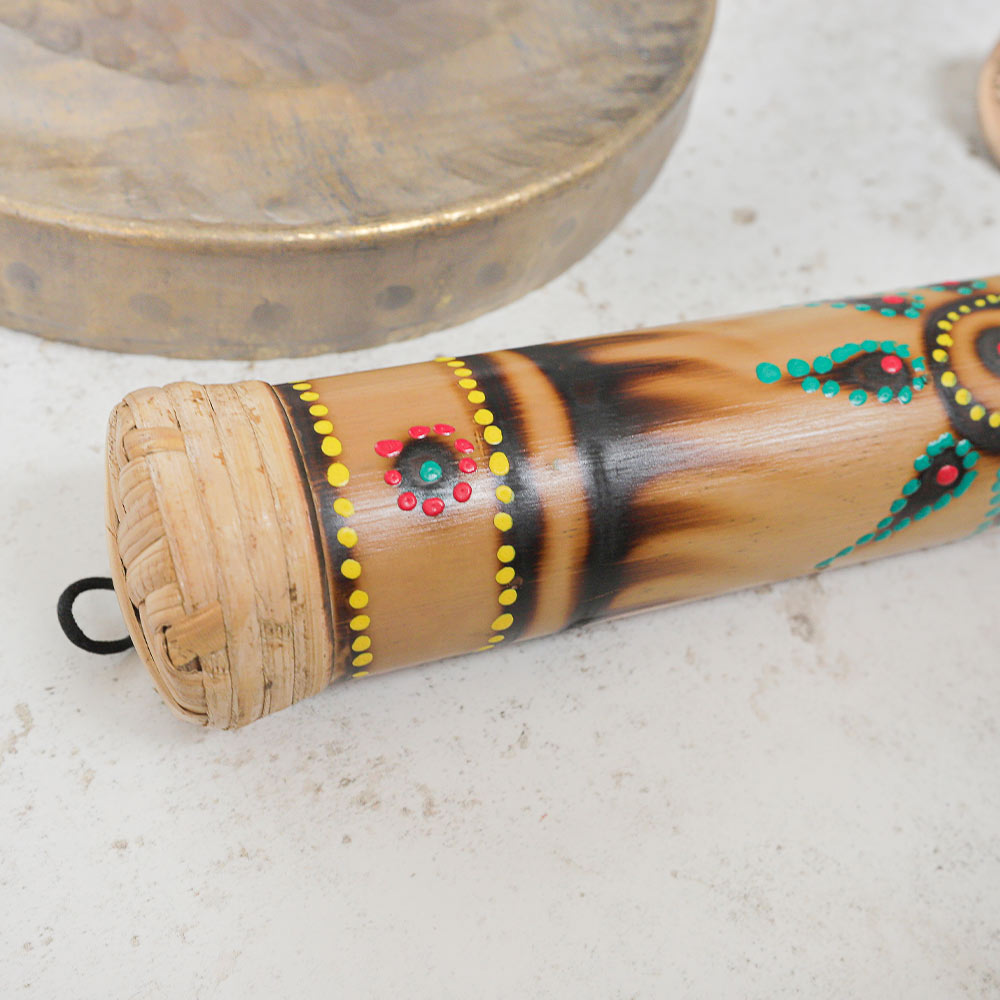 Bamboo Painted Bajawa rainstick close up alongside other sound therapy instruments