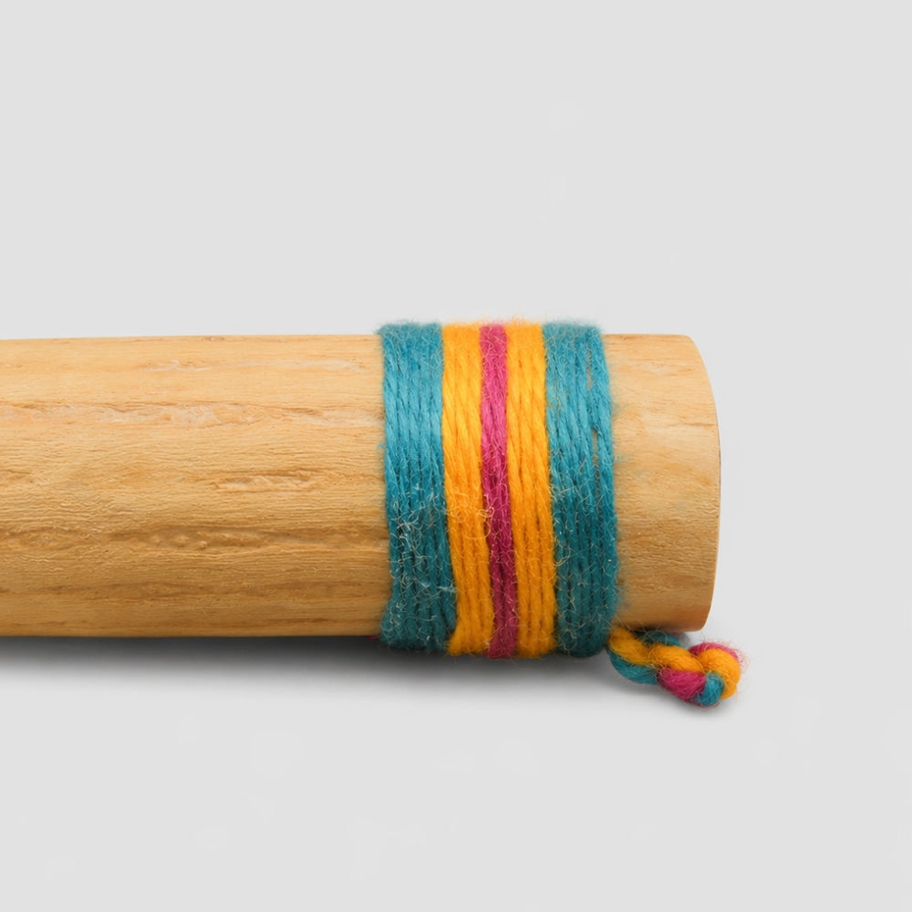 Close-up of the end of a cactus rainstick rain maker instrument, highlighting the colourful woven band wrapping around the end.