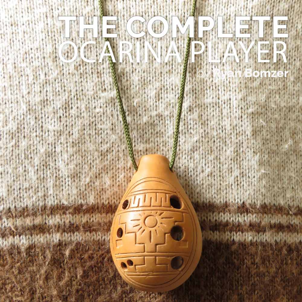 Wooden ocarina with a string on a textured fabric background