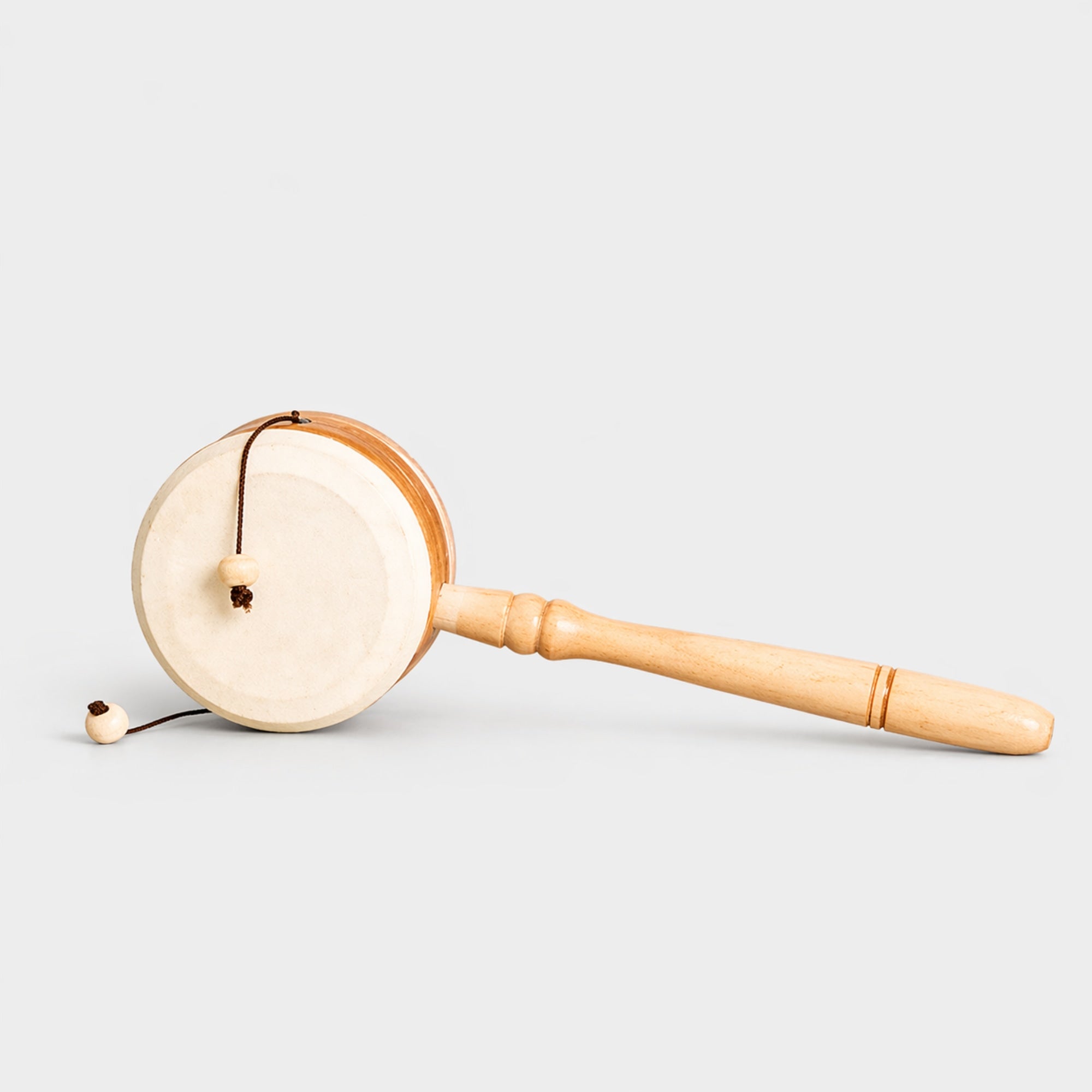 wooden traditional monkey drum on grey background