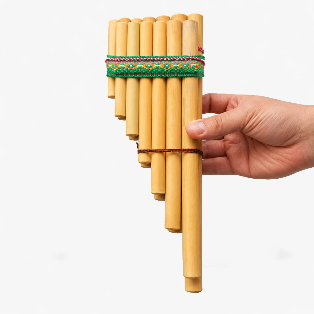 Peruvian bamboo Zampona panpipes held in hand to show size and scale.