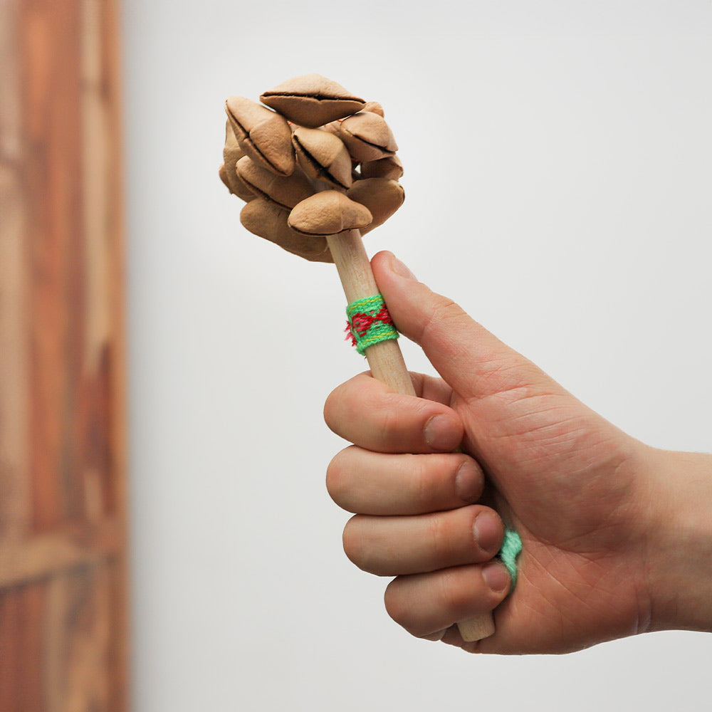 Handheld Peruvian Lima Stick Shaker, crafted from wood, creates rhythmic sounds when shaken, ideal for percussionists.
