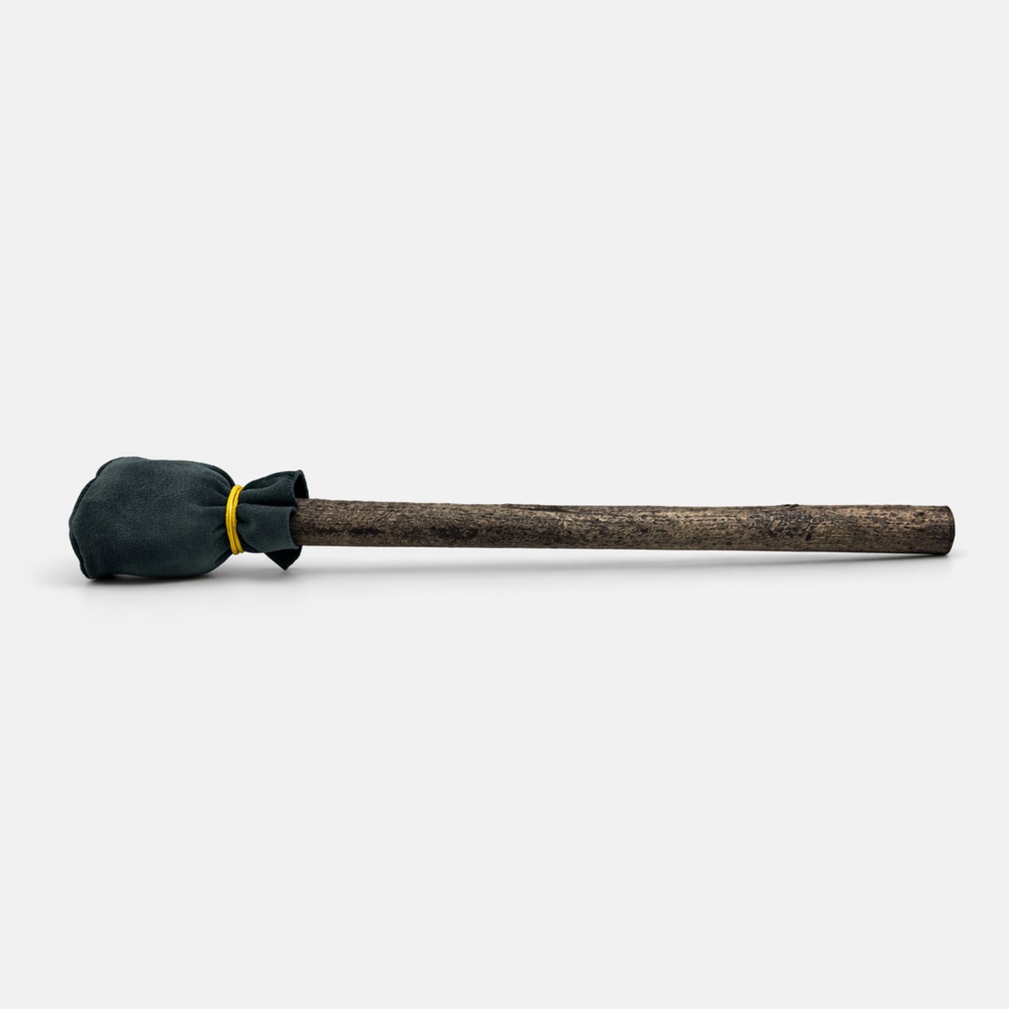 Wooden shamanic drum mallet with a black grey cushioned head on a white studio background