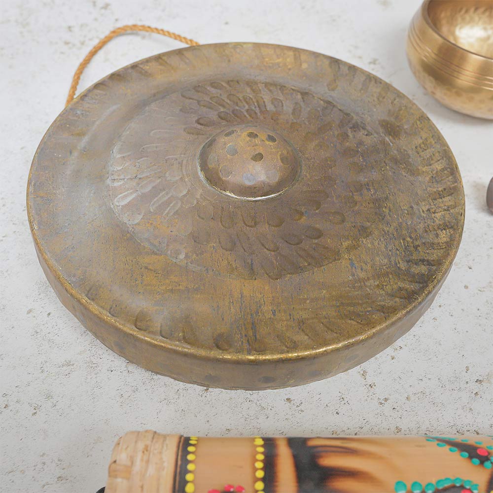 Close up of Vietnamese Gong showing its texture and other sound therapy instruments