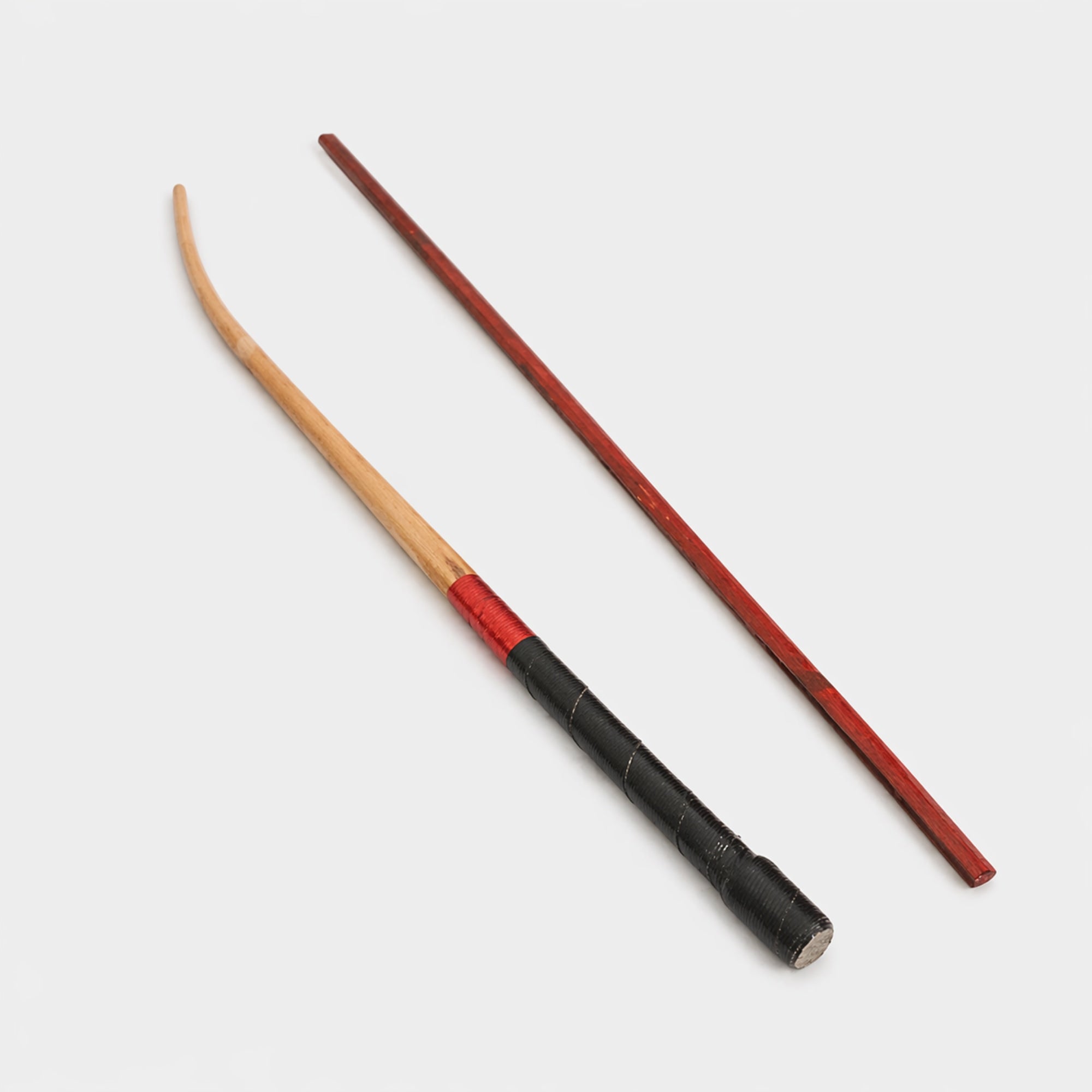 Two wooden stick beaters with red and black accents on a white background