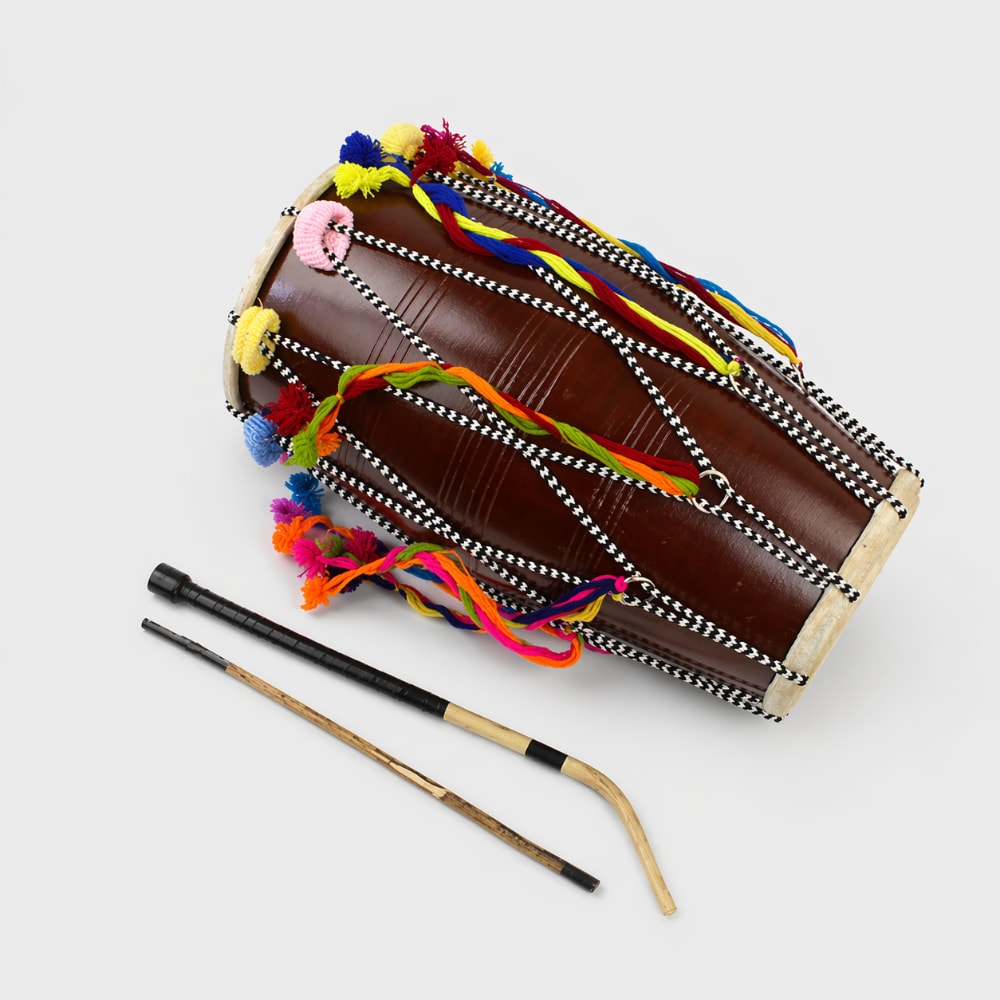 fancy dhol wedding drum with beaters on grey background 