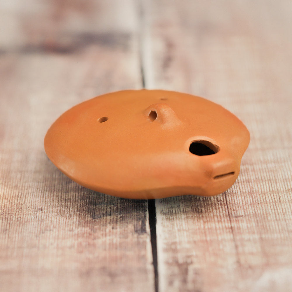 close up of back of nazca ocarina