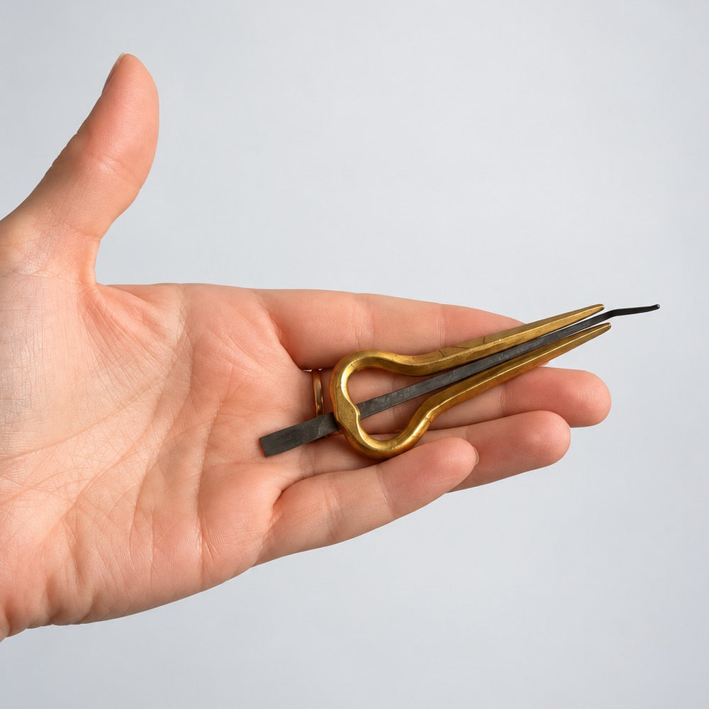 hand holding brass jaw harp