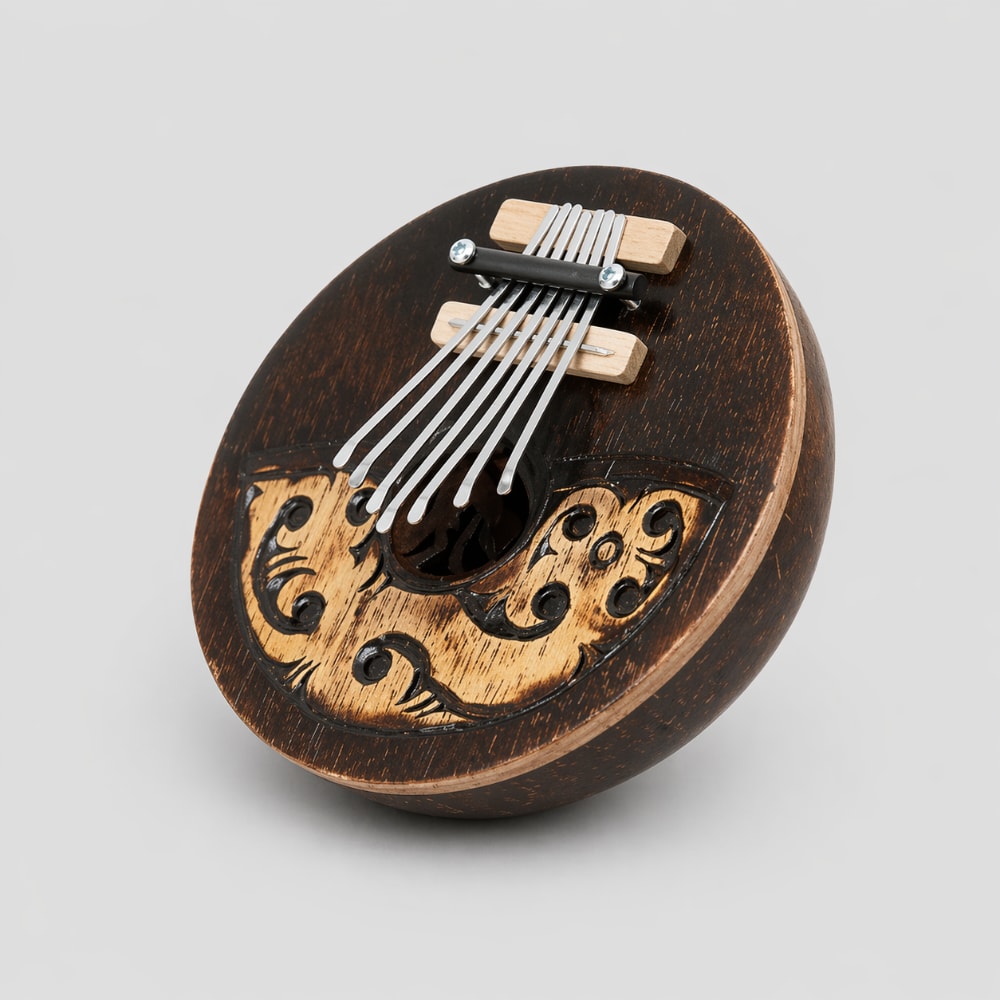 Dark wood and coconut kalimba on a light grey studio background