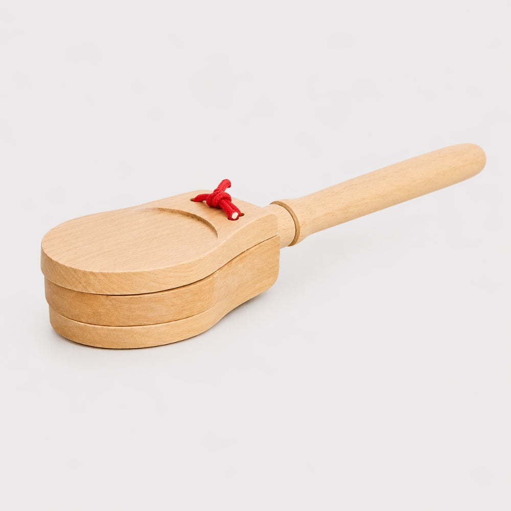 wooden castanets on wooden handle white background 