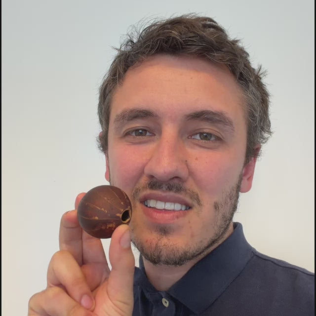 dual tone whistle being played by smiling man 
