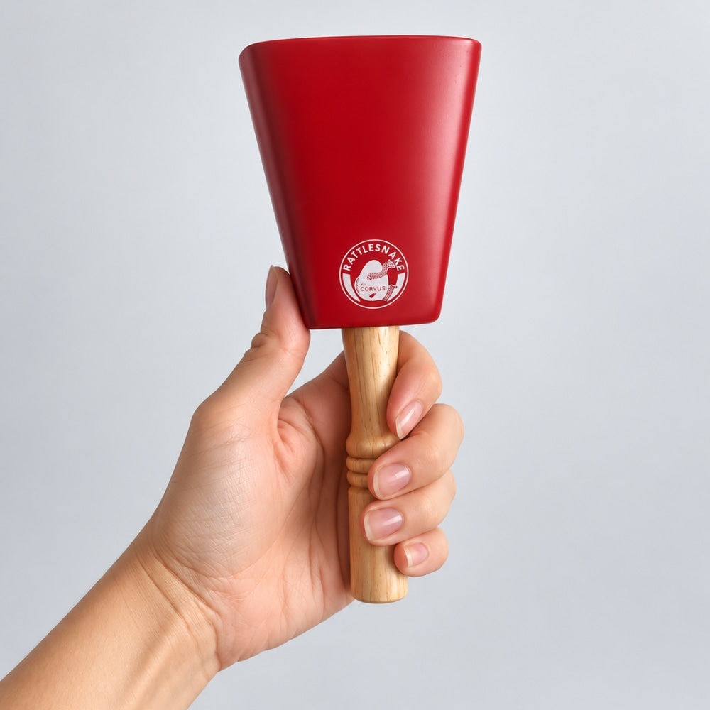 hand holding red cow bell