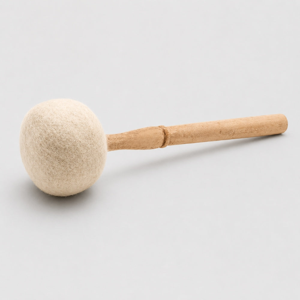 Single wool mallet beater with a wooden handle on a light grey studio background