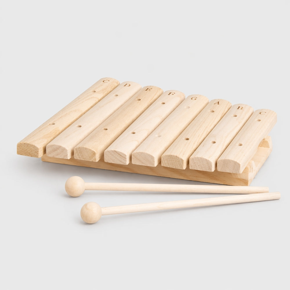 Wooden xylophone with two mallets on a light gray background